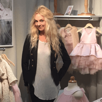 Fashion Designer Heidi Schwarck stands among her creations