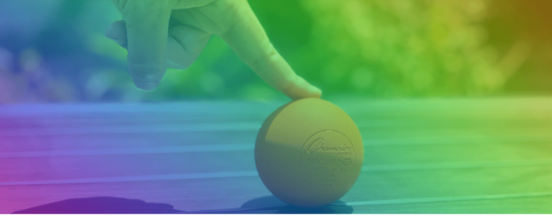 Rainbow colors of finger touching down on an orange ball