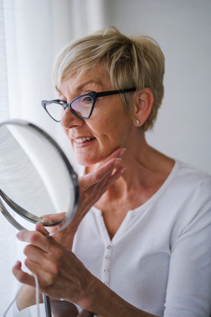 Elderly Woman at home having skin care routine