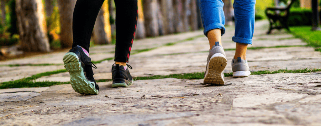 Close up of womens shoes walking along a stone path