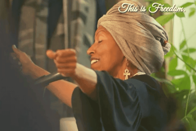 woman with head wrap singing