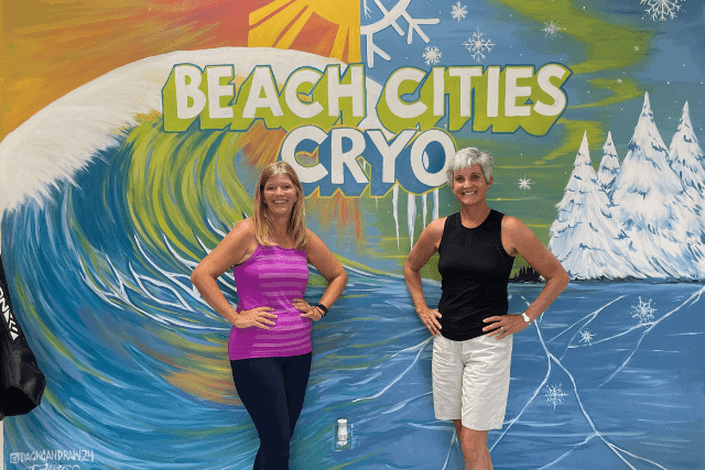 Two ladies pose at Cryo mural