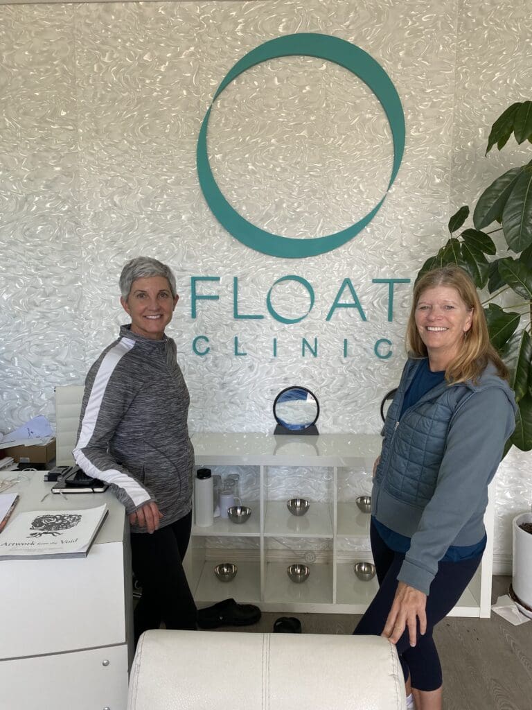 Lisa and Nancy posing at Float Clinic signage