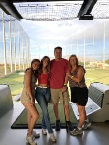 Nancy and her family at Top Golf