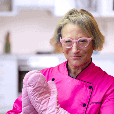 Female chef wearing pink in the kitchen