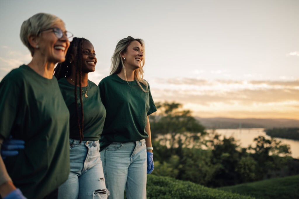 Healthy women smiling outdoors during sunset, promoting wellness and fitness.