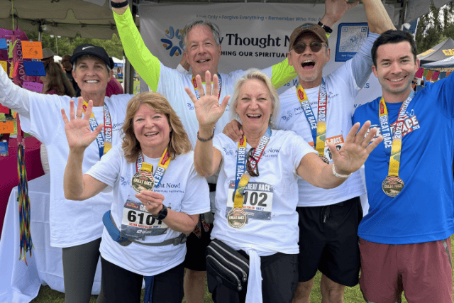 Celebrate group of diverse people smiling and waving at a charity race event.