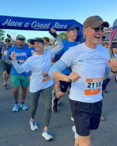 Enjoying a fun race event with smiling runners crossing the starting line.